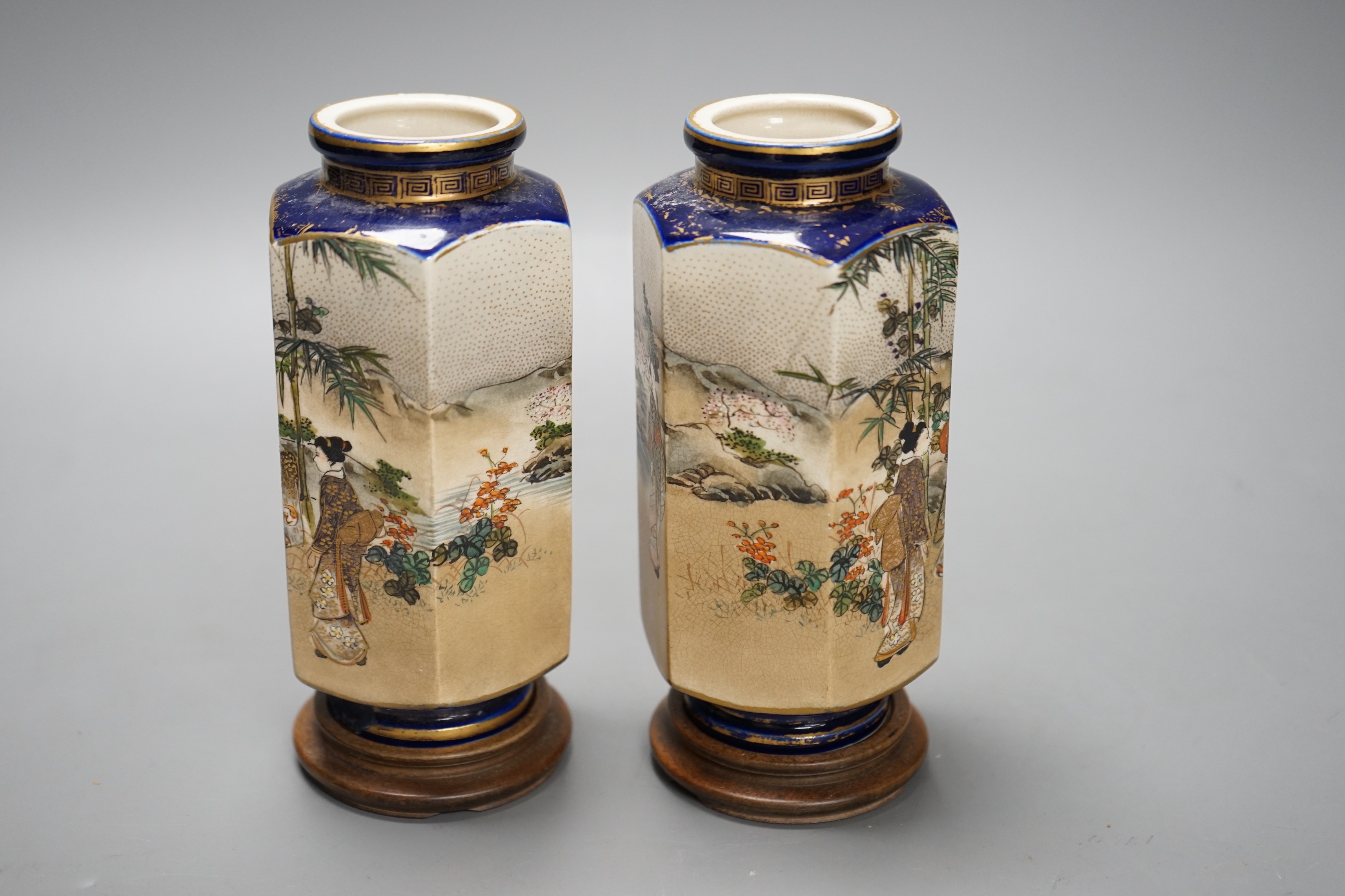 A pair of Japanese Satsuma pottery hexagonal vases, Meiji period, on stands 16cm